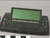 A small electronic piece that consists of a pop-up screen attached to a keyboard.