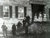 Five doctors and three nurses stand on a staircase in front of a stone building